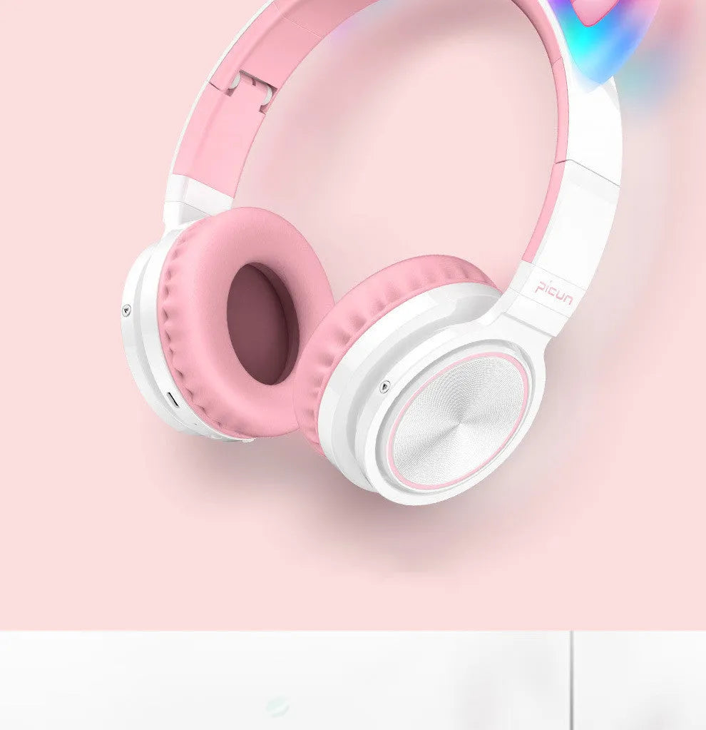 Pink white Luminous Bluetooth over-ear headphones showing protein ear cushions and braided cable.