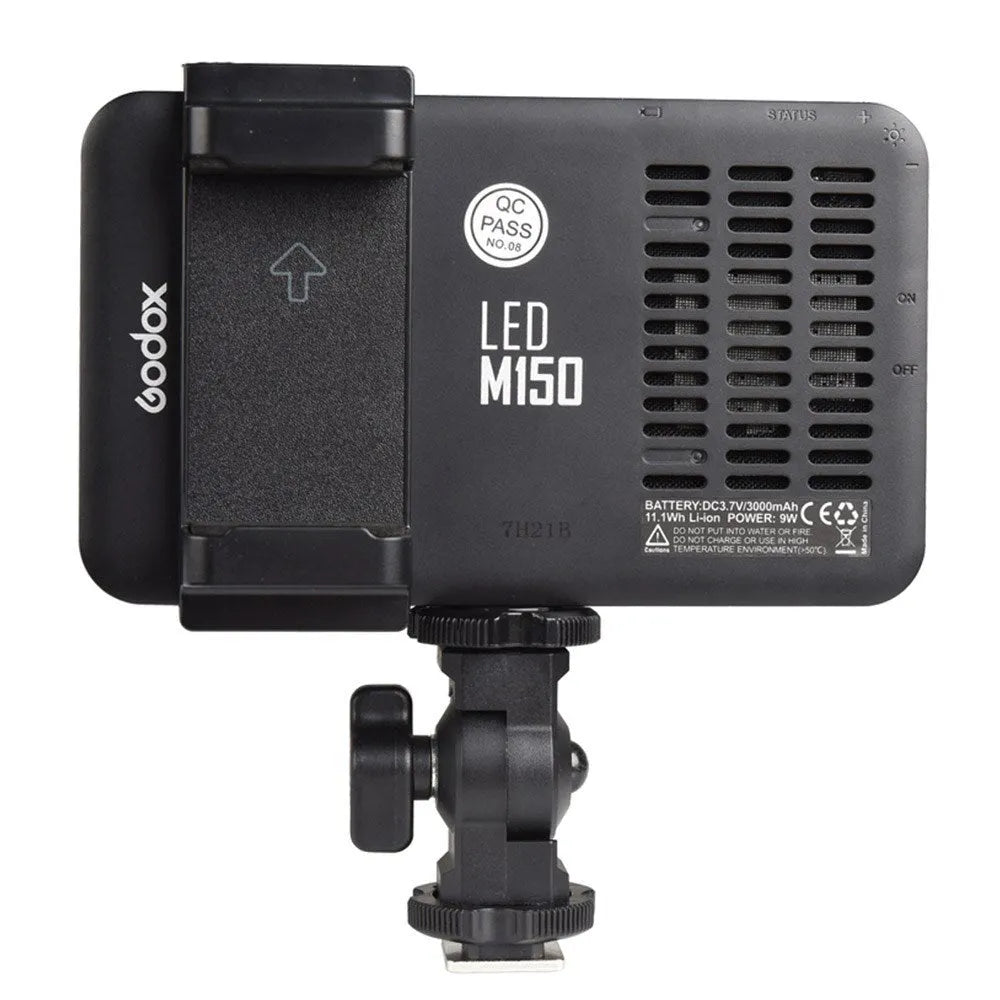 Slim silver Shenniu M150 LED video light with bracket on a mobile phone.