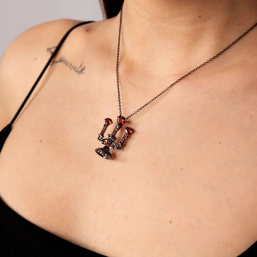 Women's retro candlestick pendant necklace on a gothic cross chain.