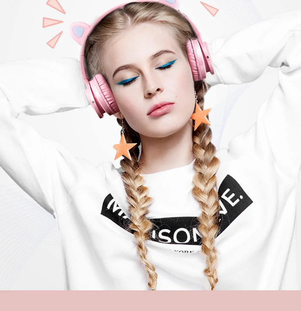 Pink white Luminous Bluetooth over-ear headphones showing protein ear cushions and braided cable.