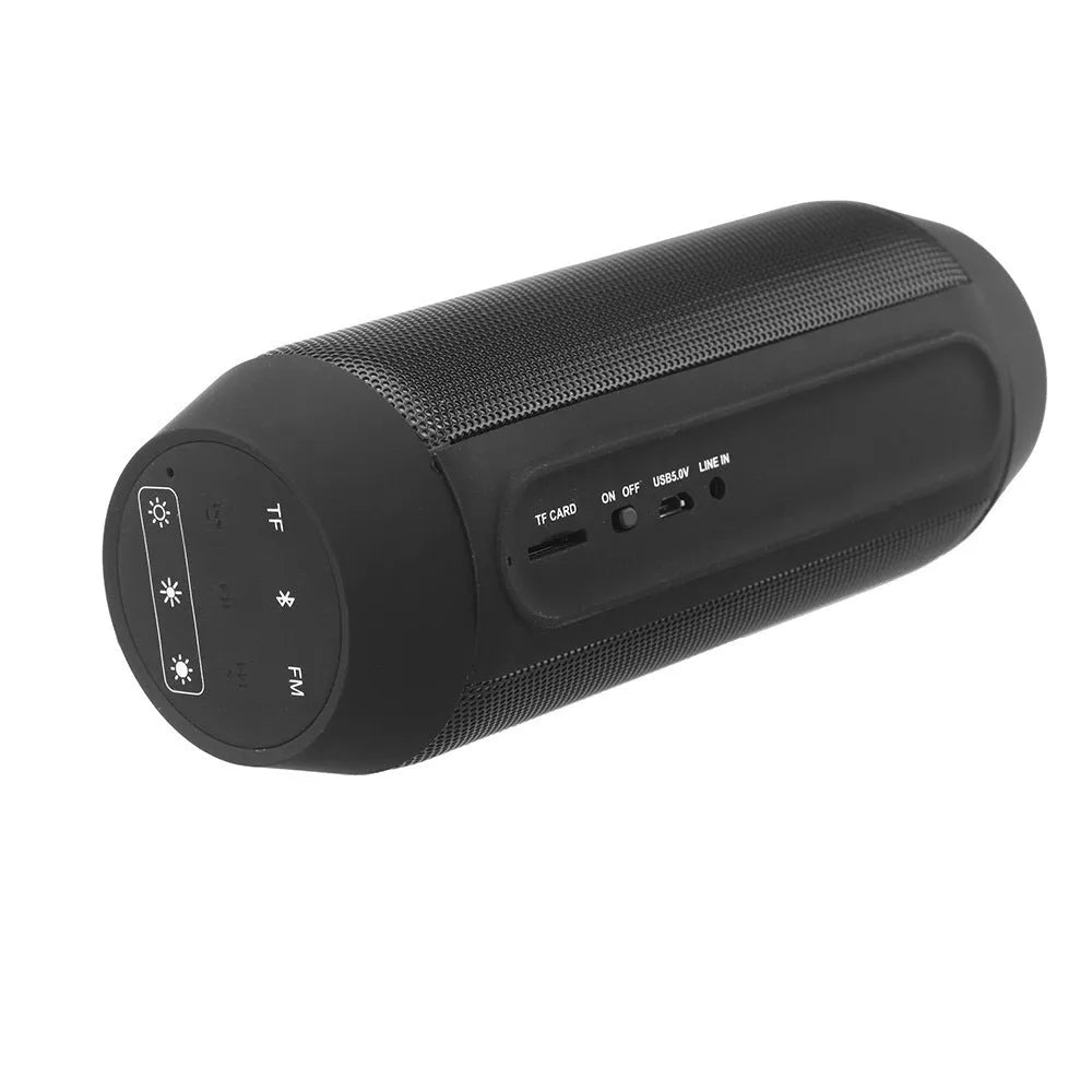 Mini black and white Bluetooth stereo speaker with colourful LED lights on a table.
