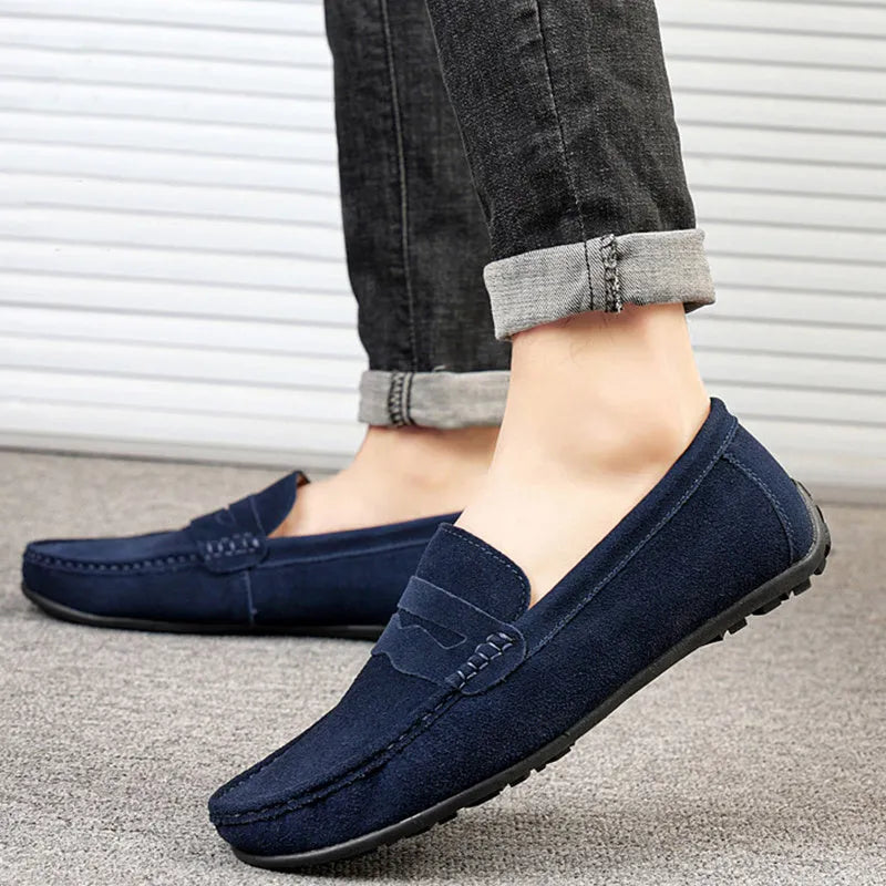 Men's solid colour suede loafers with round toe and flat rubber sole.