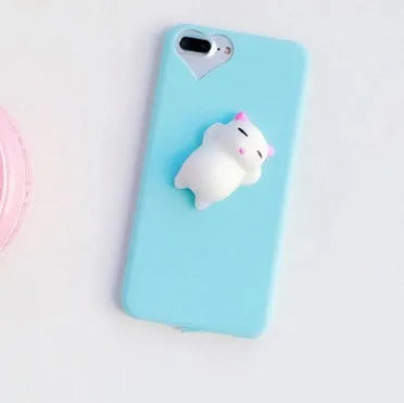 Soft silicone iPhone case with a raised 3D cartoon cat design, shown in pink.
