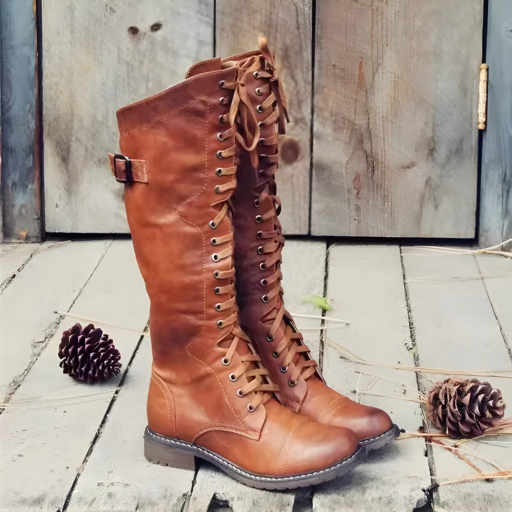 Women's black high leg boots with a chunky low heel and round toe on a solid background.