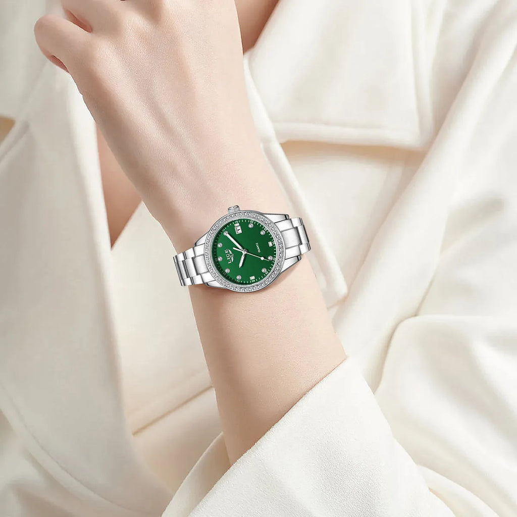 Silver fashion quartz watch for women with diamond-encrusted bezel and luminous dial on a 34mm stainless steel case.