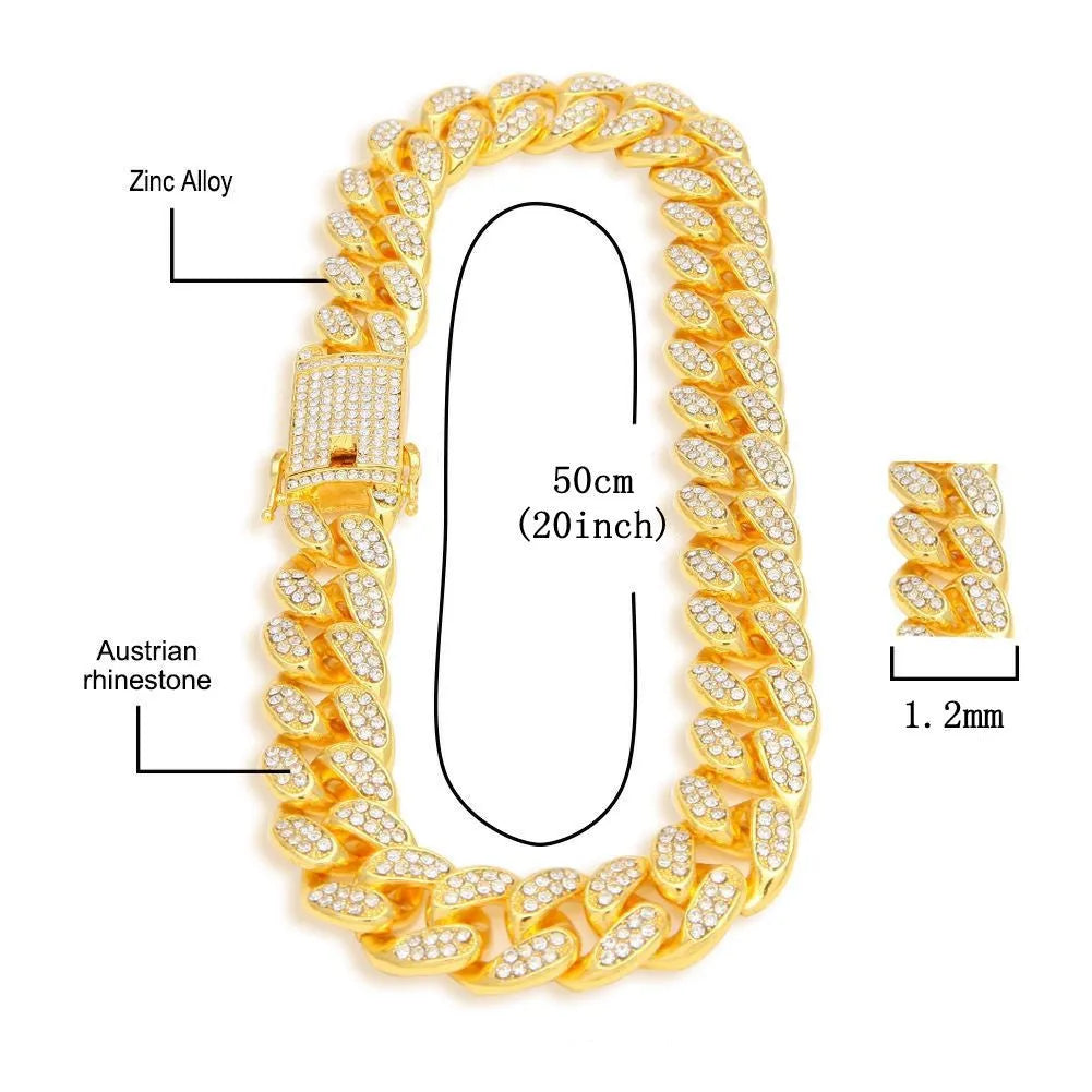 Gold Roman numeral square watch with black mesh band, bracelet, and necklace set on a table.