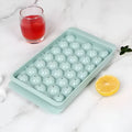 Blue silicone ice cube tray with lid showing 33 round compartments for homemade ice