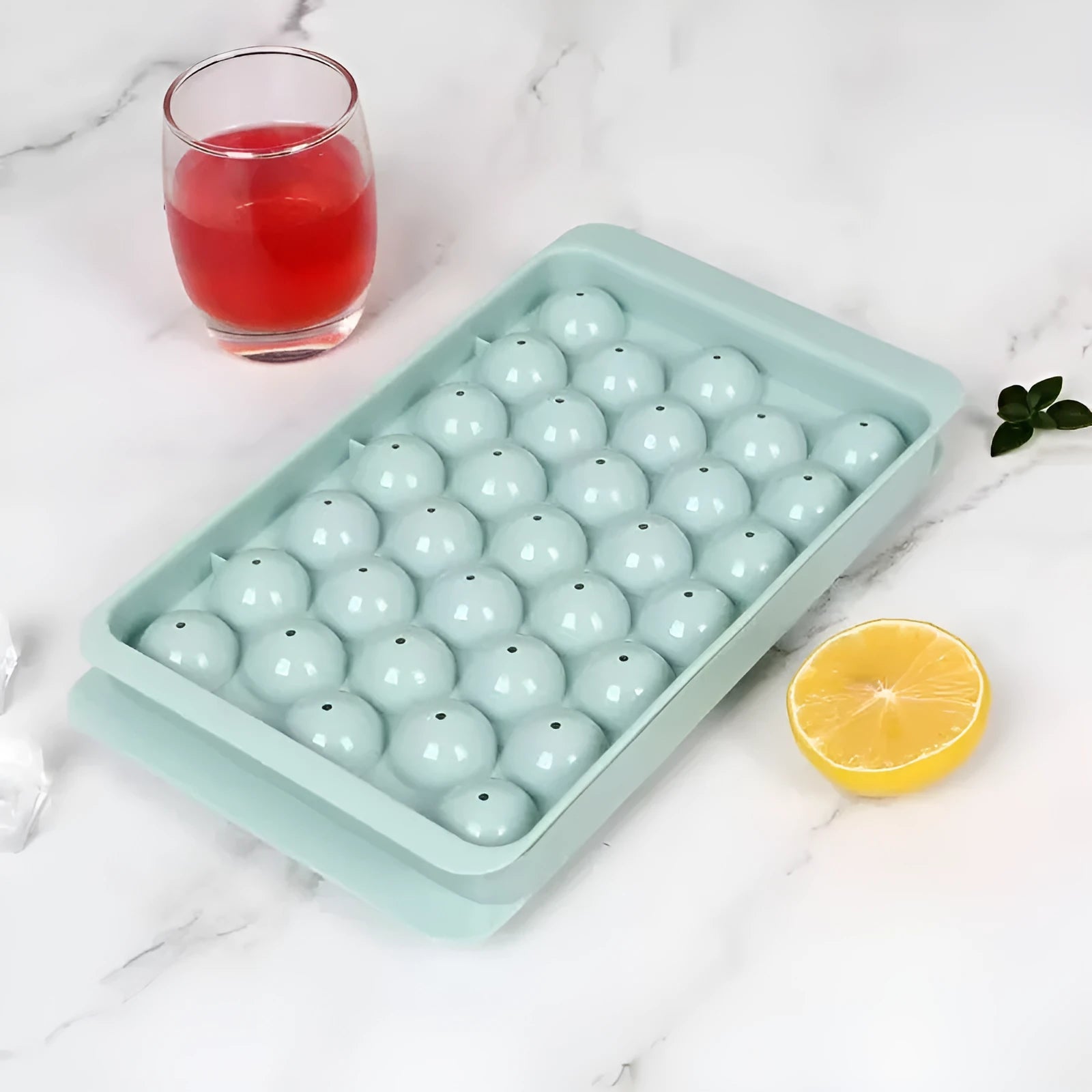Blue silicone ice cube tray with lid showing 33 round compartments for homemade ice