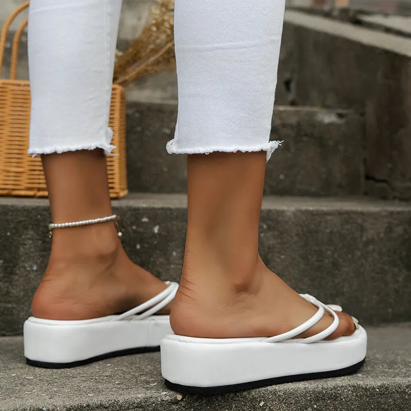 A pair of thick-soled flip-flops with a herringbone-patterned strap in one of six available colours.