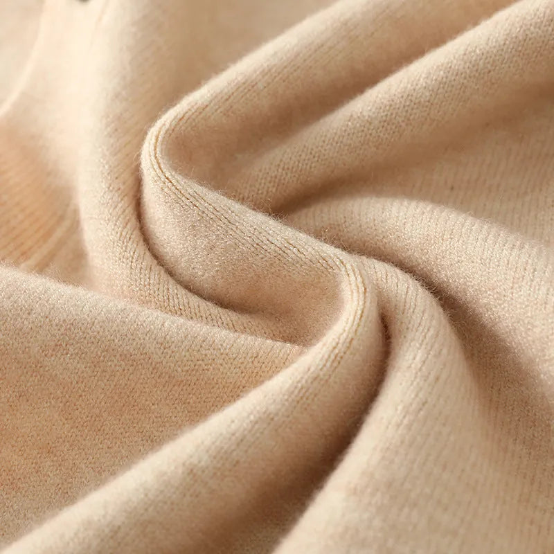 Man wearing a loose beige V-neck Andy Velvet knitted cardigan coat.