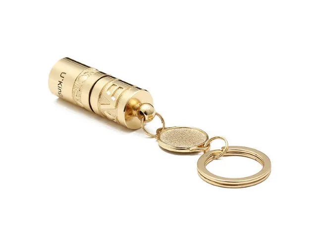 Gold-coloured waterproof mini LED keychain flashlight with zinc alloy housing on a key ring.