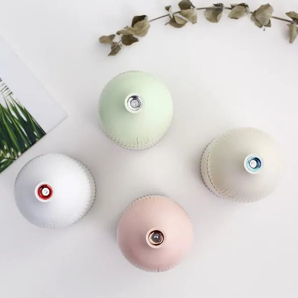 White cylindrical ultrasonic aromatherapy diffuser with LED light and 300ml water capacity.