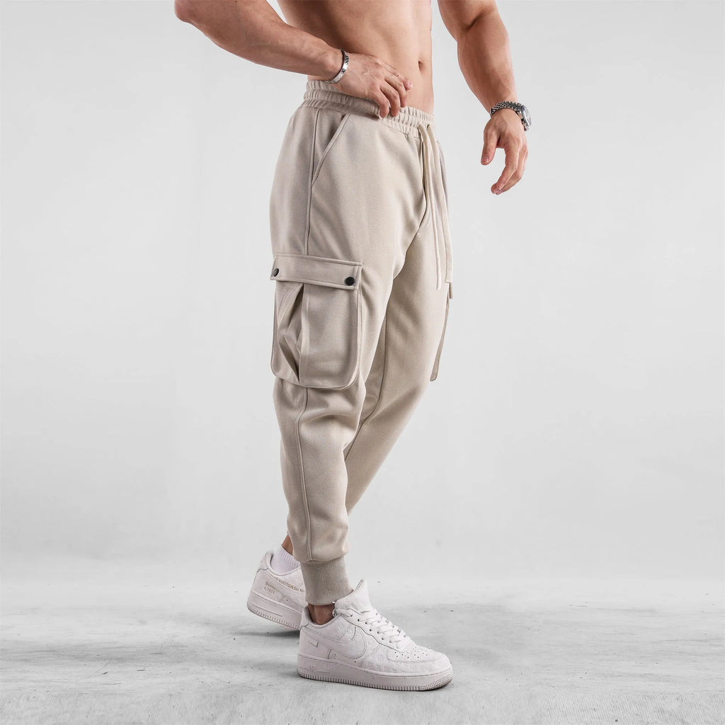 Men's loose cotton sports trousers with ankle-tied cuffs in solid colours