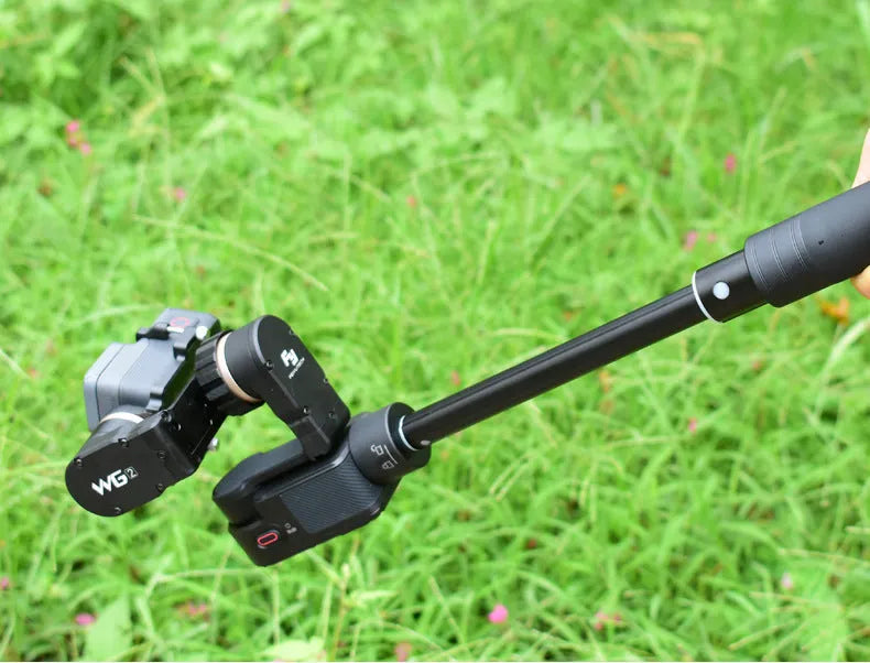 Black retractable aluminium selfie stick with hand-held stabiliser and phone grip, shown extended and collapsed.