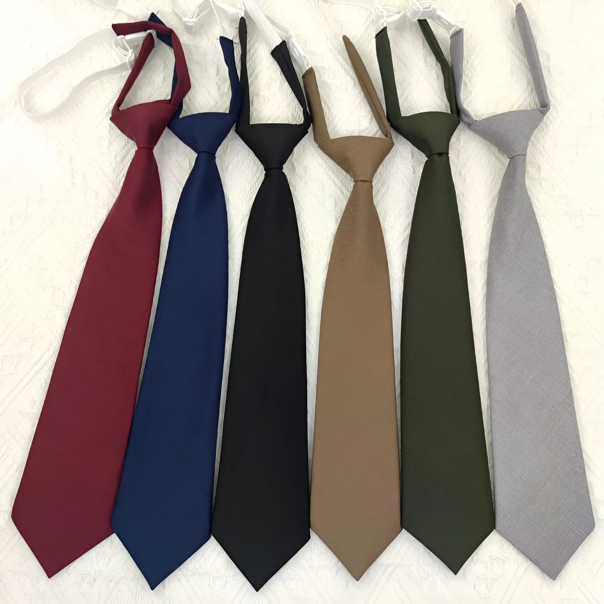 Men's solid colour cotton bow tie in arrow style, showing navy blue option.