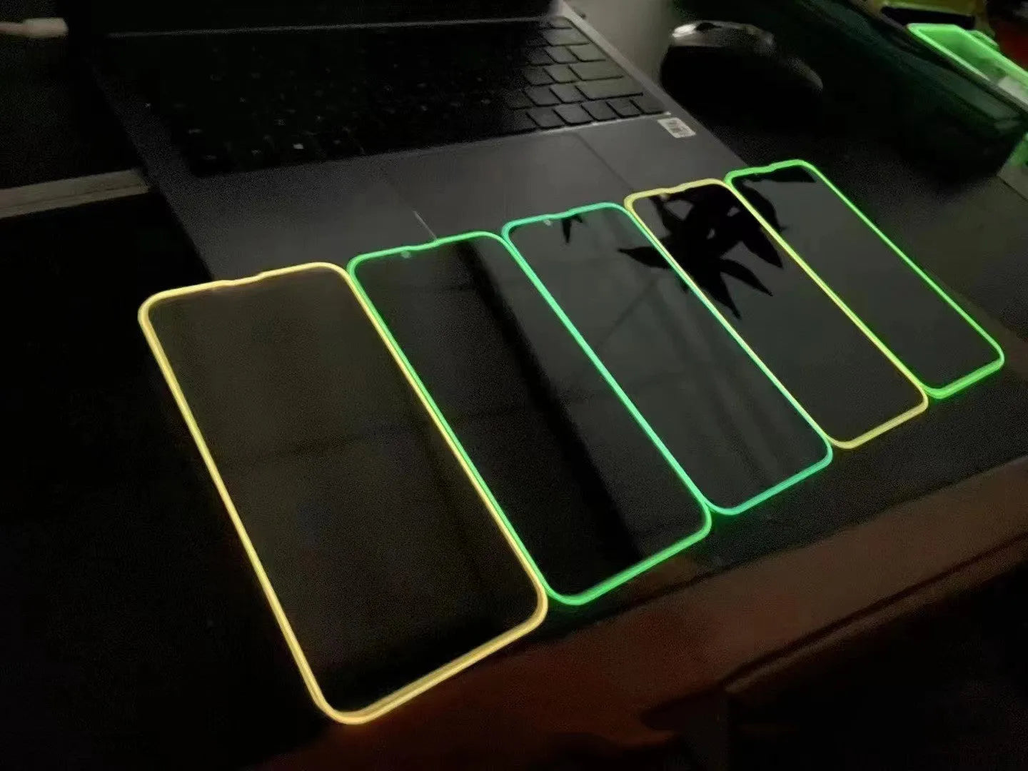 Fluorescent luminous tempered glass screen protector for iPhone on a phone.