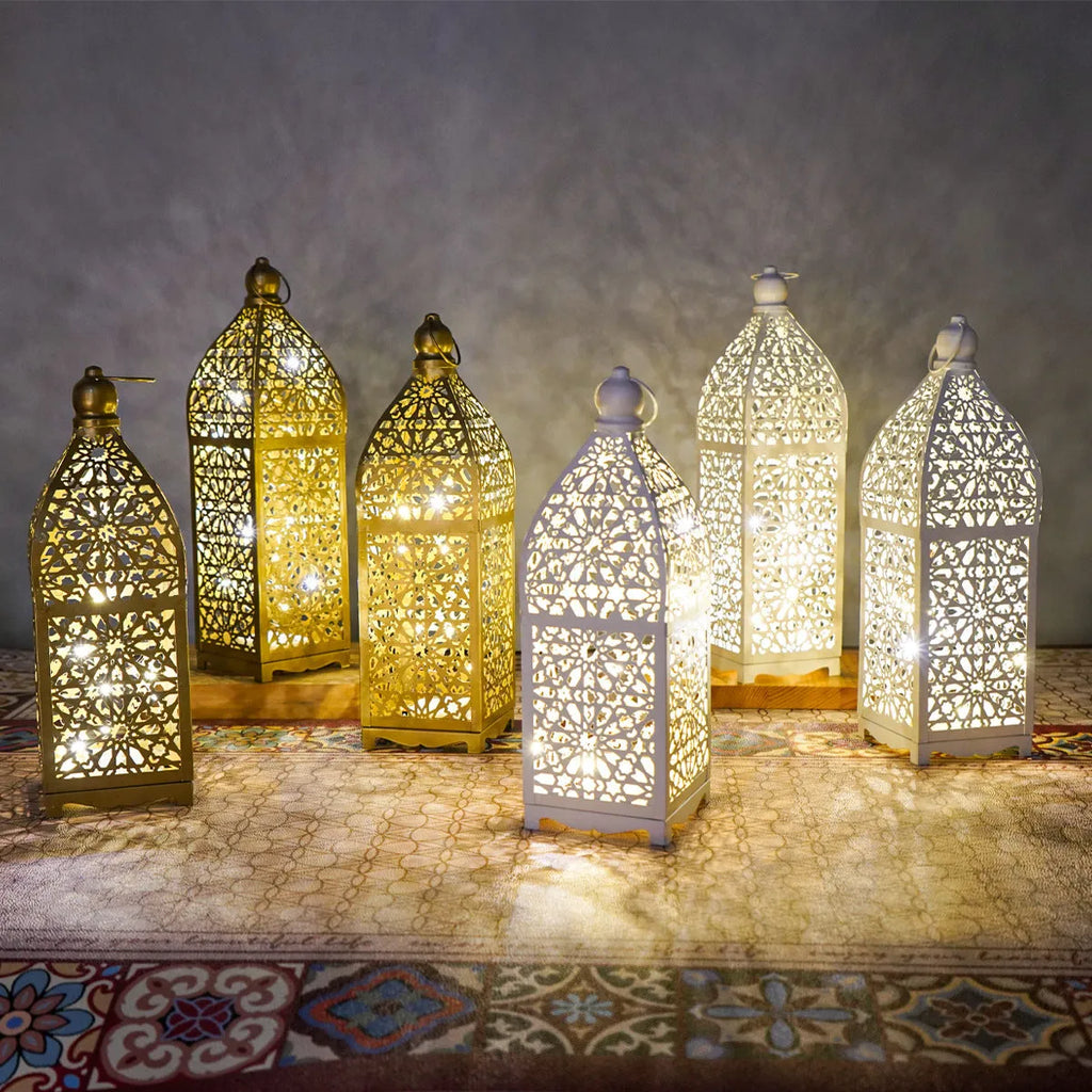 Gold L decorative iron barn lantern with hollow four-corner design on a tabletop