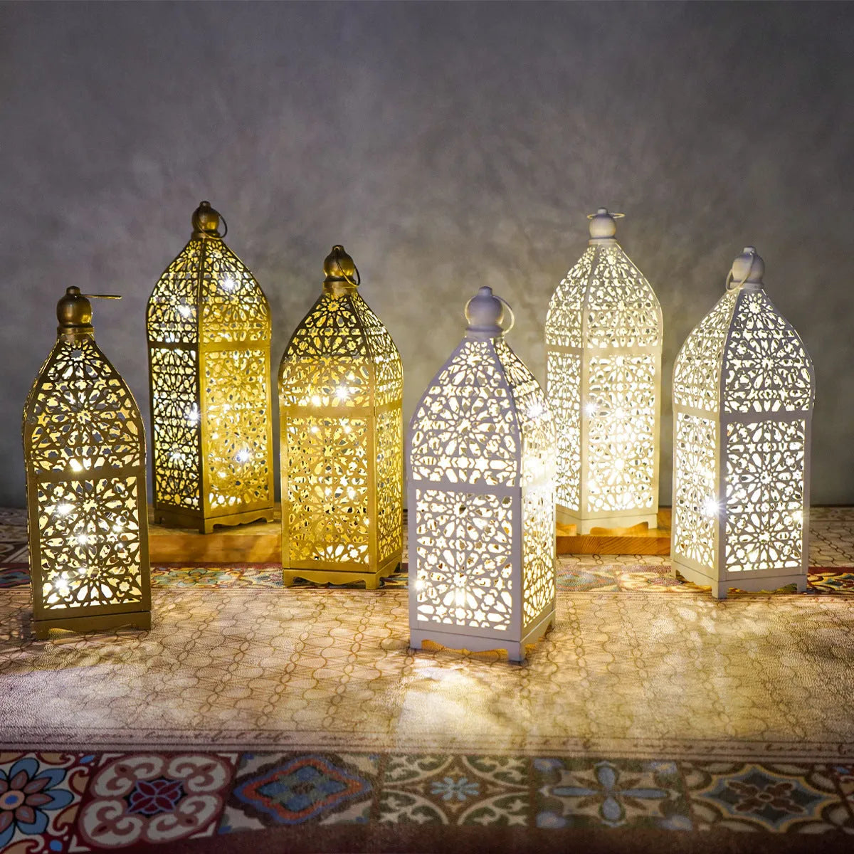 Gold L decorative iron barn lantern with hollow four-corner design on a tabletop