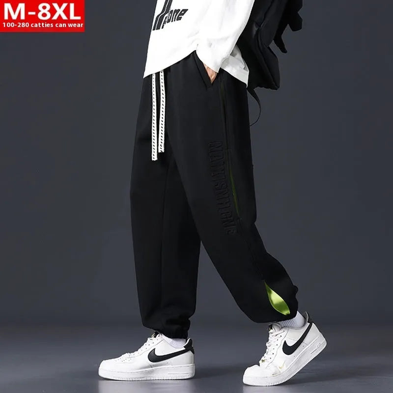Men's loose fit cotton trousers with banded ankle and collage stitching detail in grey green