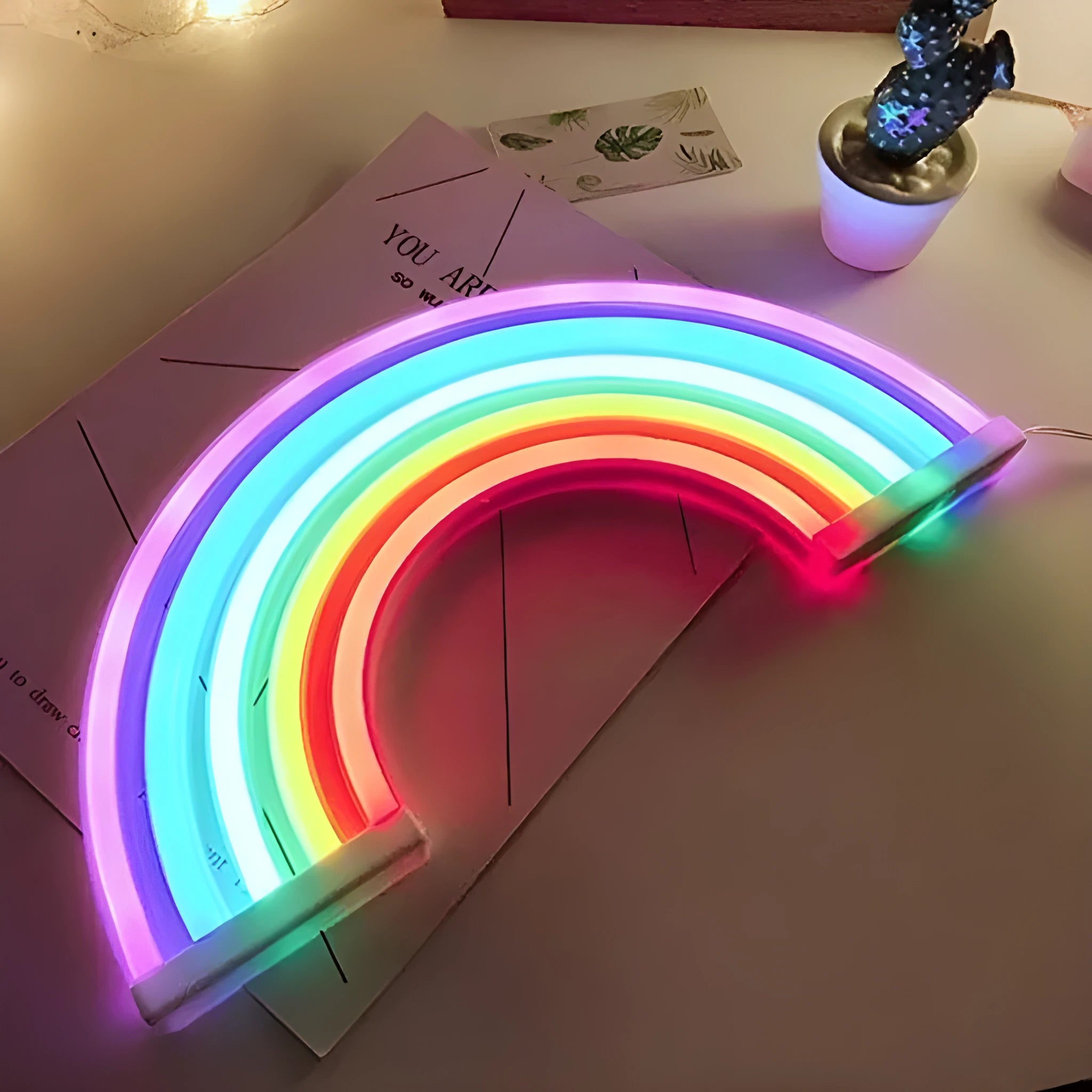 LED wall hanging rainbow neon light with compact 30x2x16cm housing on a wall