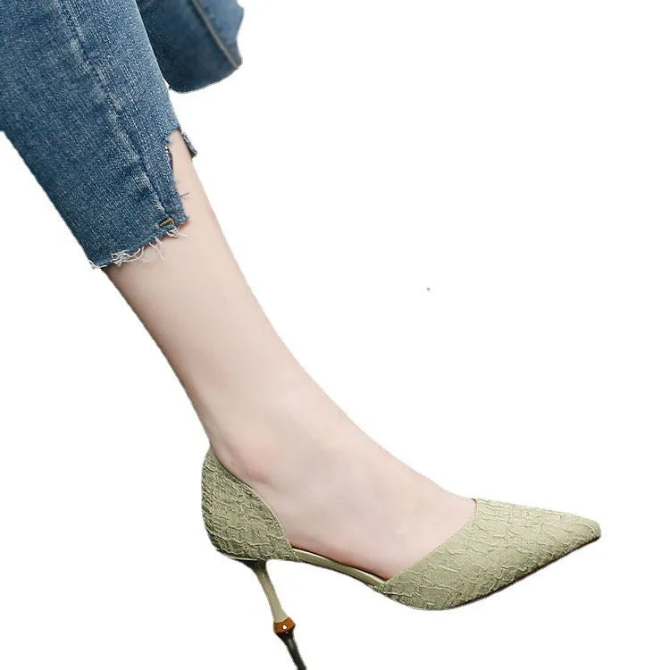 Women's black PU leather pointed toe stiletto high heels on a light background