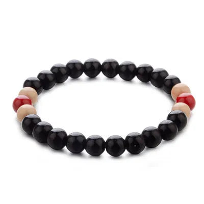 A natural stone bead bracelet with lava stone beads on a wrist, showing its ethnic style and approximately 18cm length.