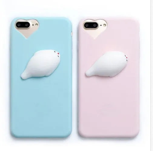 Soft silicone iPhone case with a raised 3D cartoon cat design, shown in pink.