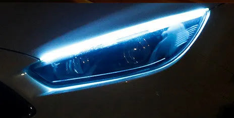 Car LED daytime running light strip with flowing turn signal indicator in silicone housing