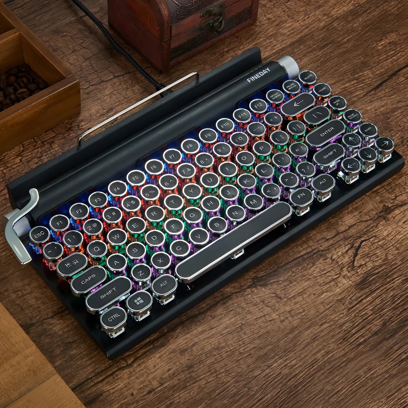 Black retro-style mechanical keyboard with typewriter keycaps and multi-colour backlighting on a desk.