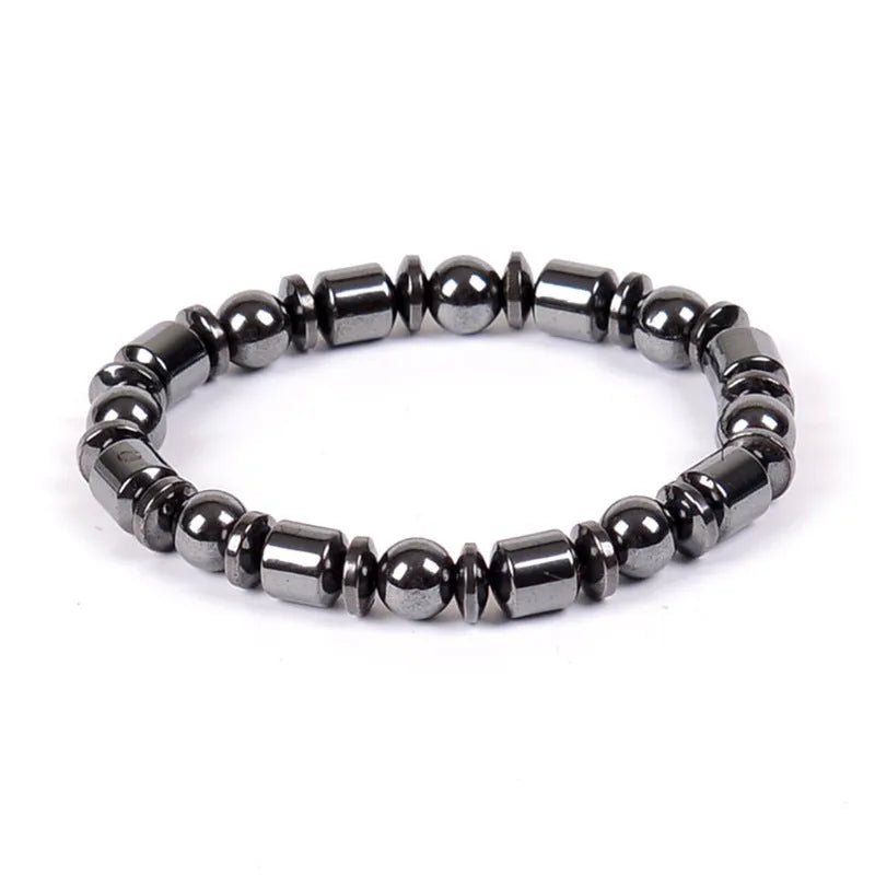 Black pentagram stone magnetic therapy bracelet with stretch fit on a wrist.