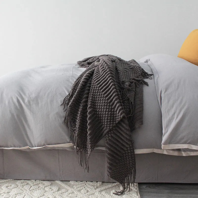 Small grey polyester blanket folded, dimensions 127 by 170 centimetres.