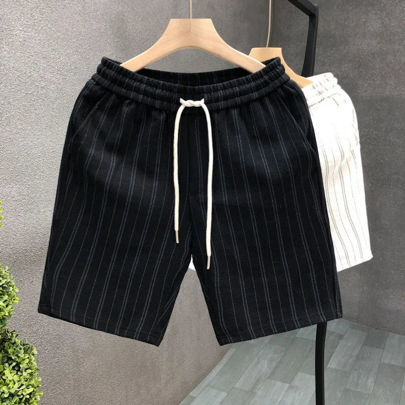 Man wearing black and white striped fleece-lined casual shorts with an elastic waistband.