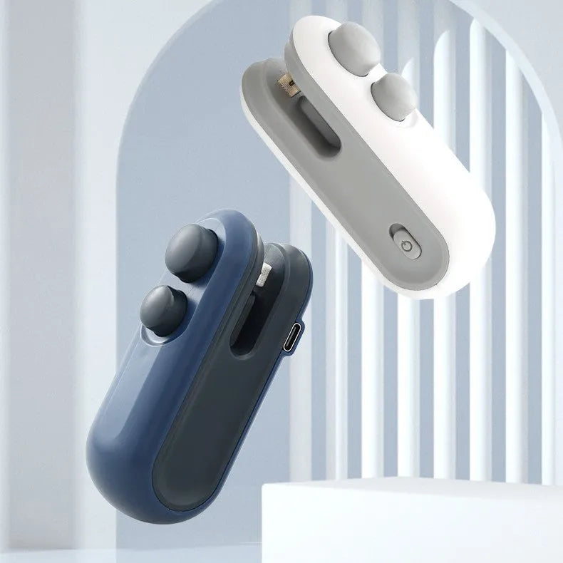 Handheld vacuum bag sealer in blue with USB charging port and cutter blade