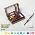 Miniature walnut wood watercolour box with brass fittings and professional paint tubes in leather case
