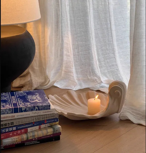 White resin decorative shell ornament for use as a fruit plate or table centrepiece.