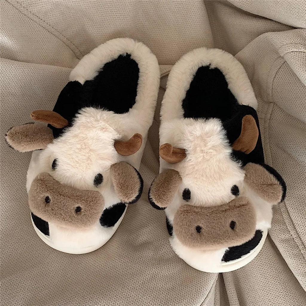 White cow-themed plush slippers for women with a non-slip textured sole.