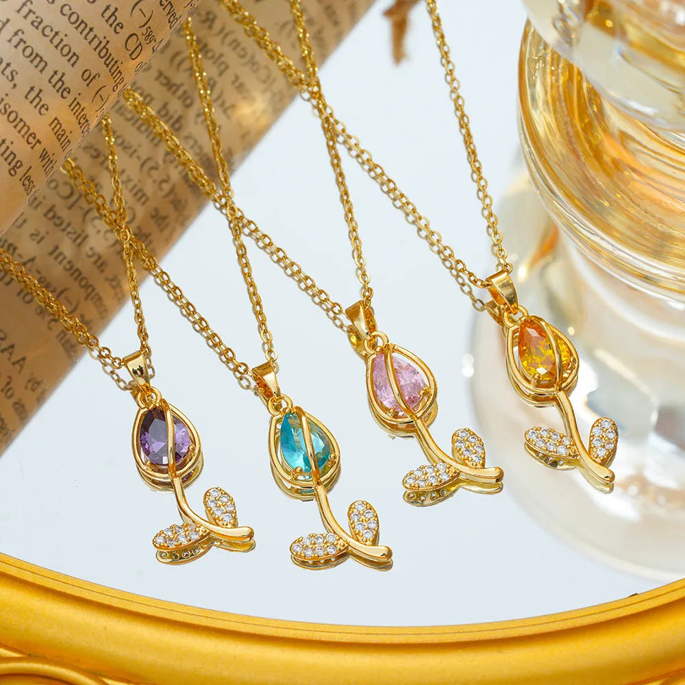 Zircon tulip pendant necklace for women in electroplated gold colours on an adjustable O-ring chain.