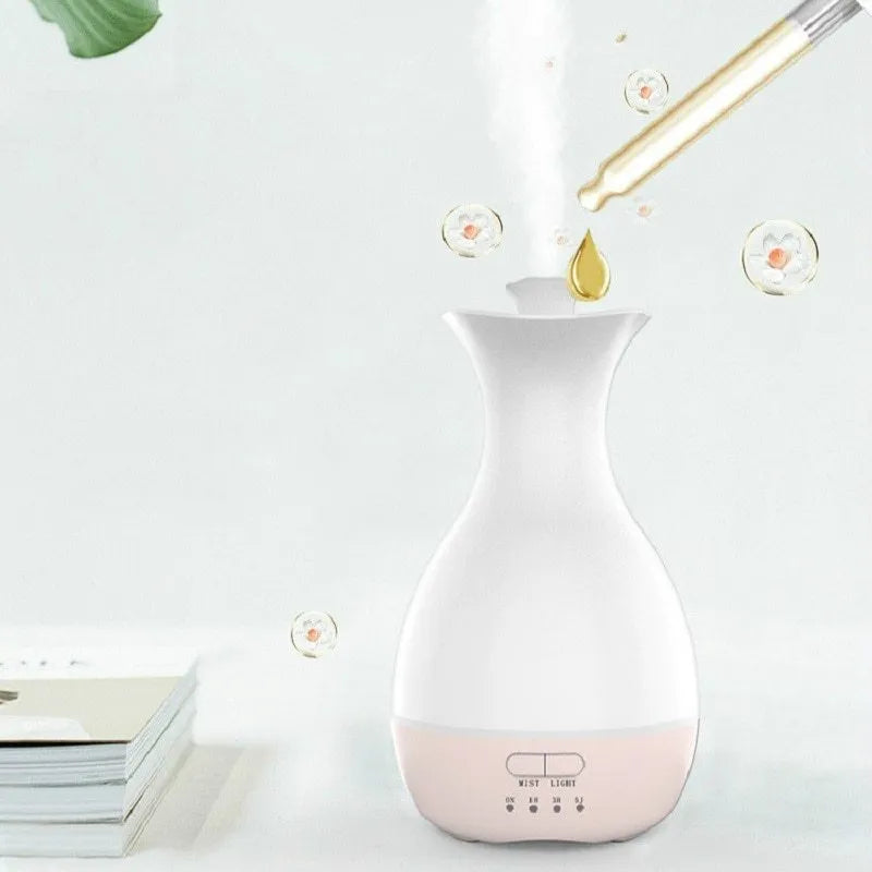 White or pink ultrasonic essential oil diffuser with 200ml tank, night light, and control buttons.