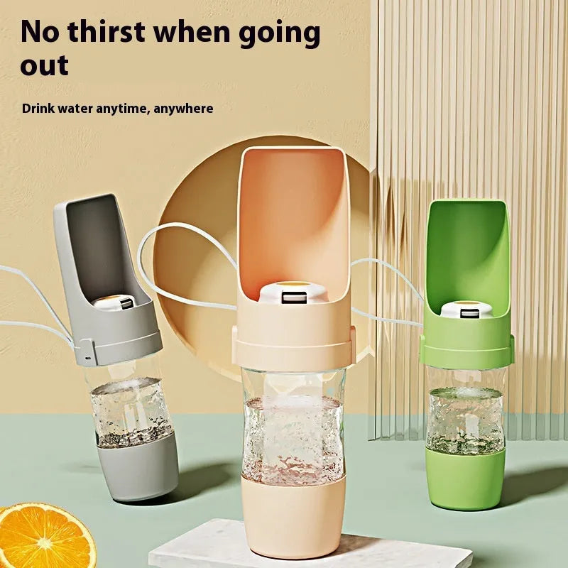 Green portable pet water bottle and food feeder with attached lanyard, showing transparent cup design.