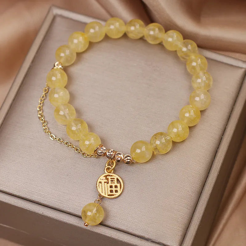 Natural citrine bracelet with Chinese character design and tassel detail