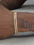 Gold colour tennis bracelet with artificial gemstone inlay on titanium steel band