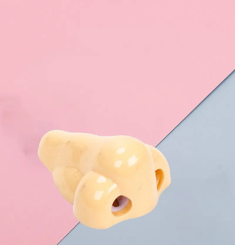 Flesh colour plastic student pencil sharpener with large nostril hole showing geometry shape
