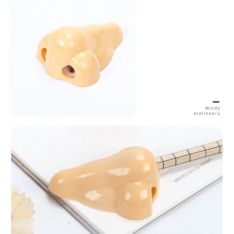 Flesh colour plastic student pencil sharpener with large nostril hole showing geometry shape
