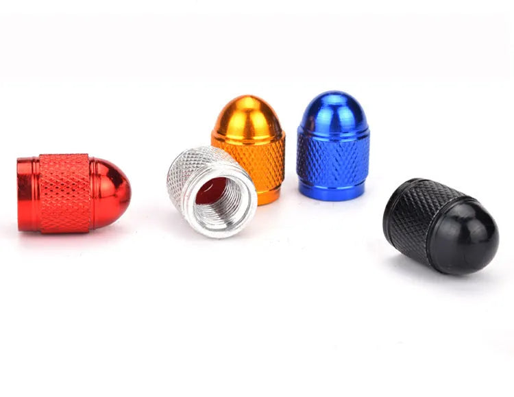 Aluminium mountain bike tyre valve cap in black, blue, gold, red, and silver colours.
