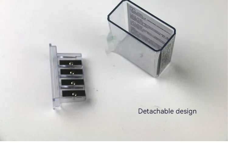 Four-hole geometric plastic pencil sharpener with included screwdriver on a white background.