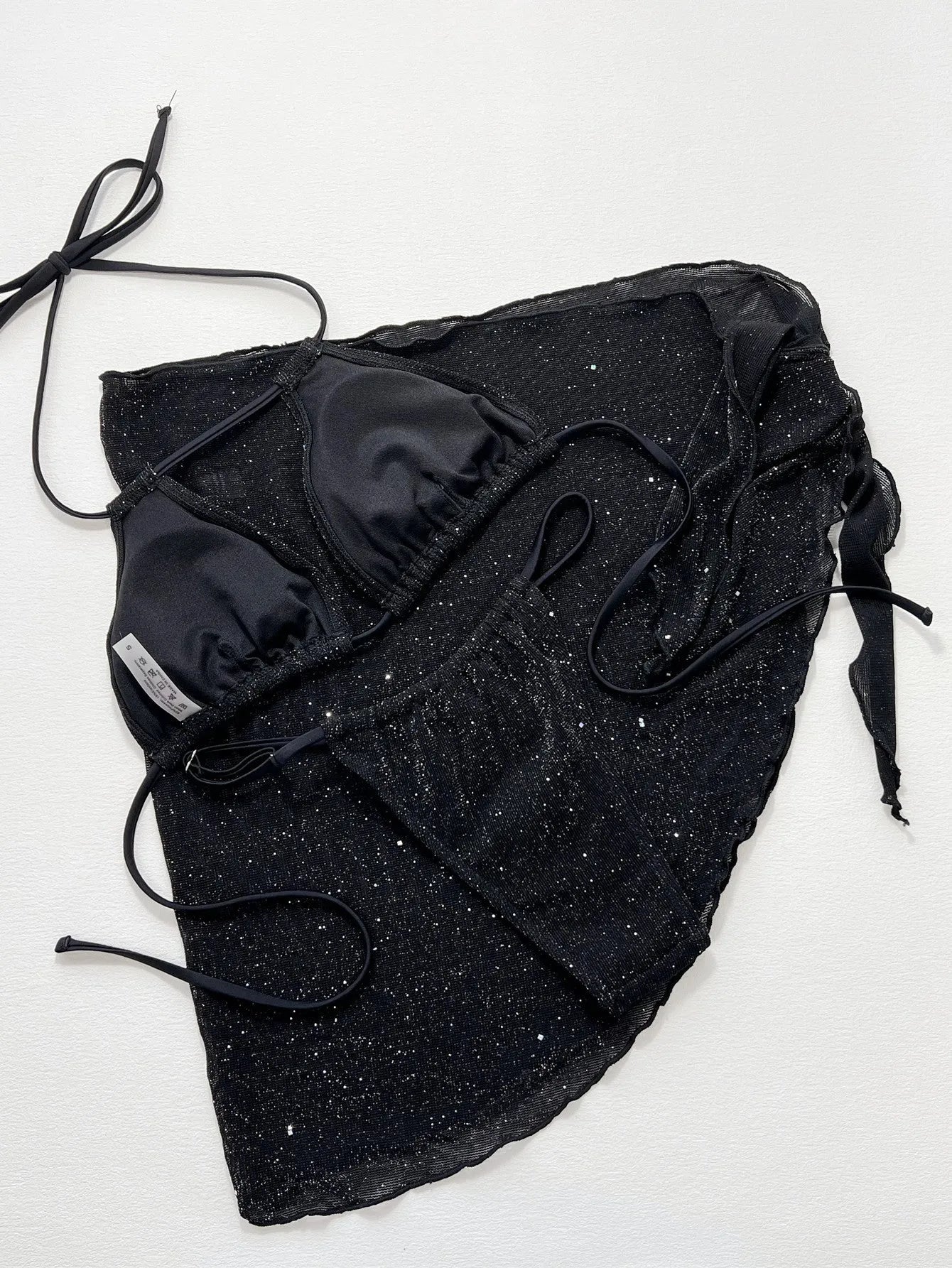 Black women's three-piece bikini swimsuit set consisting of a top and shorts on a mannequin.