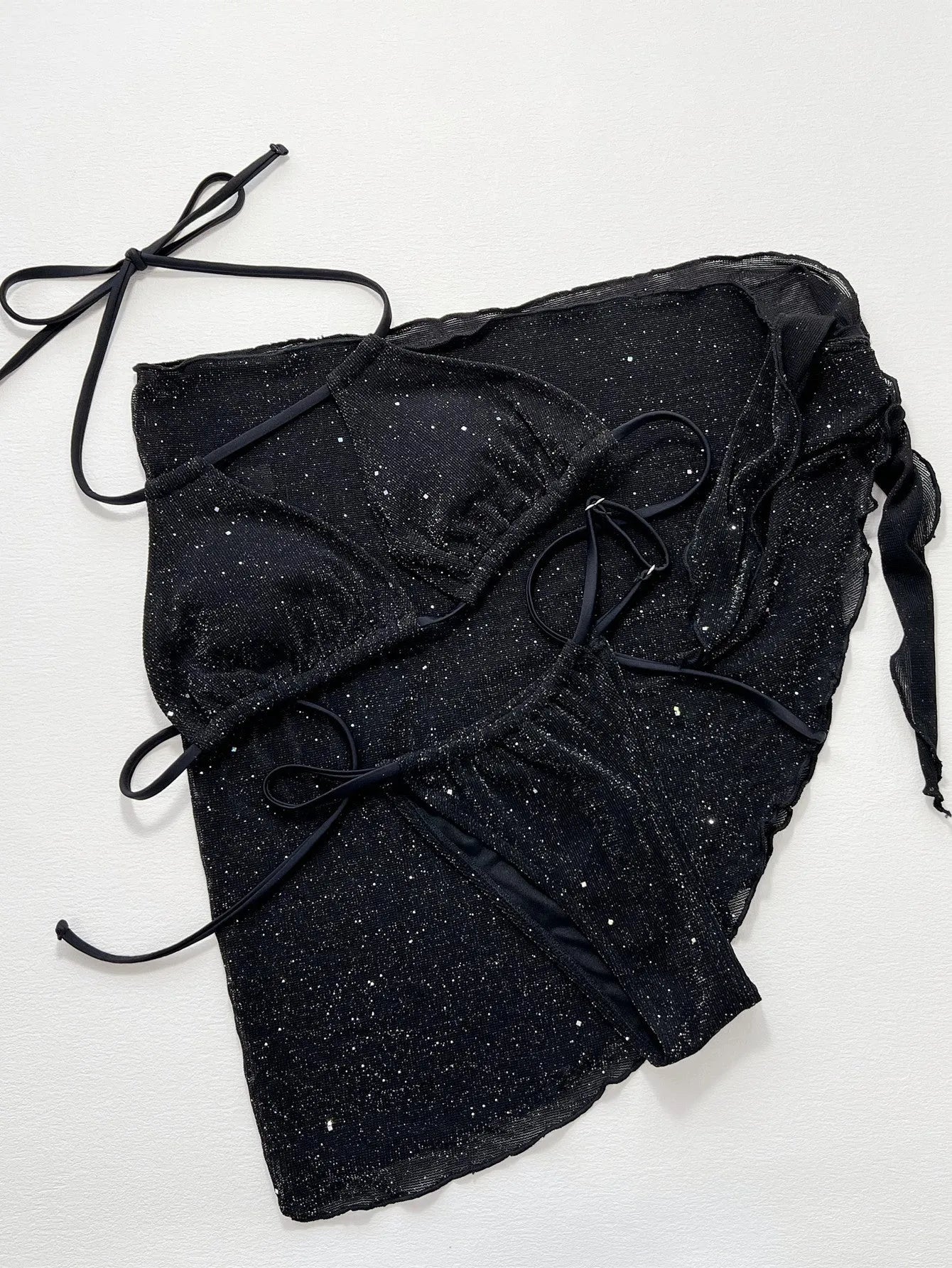 Black women's three-piece bikini swimsuit set consisting of a top and shorts on a mannequin.