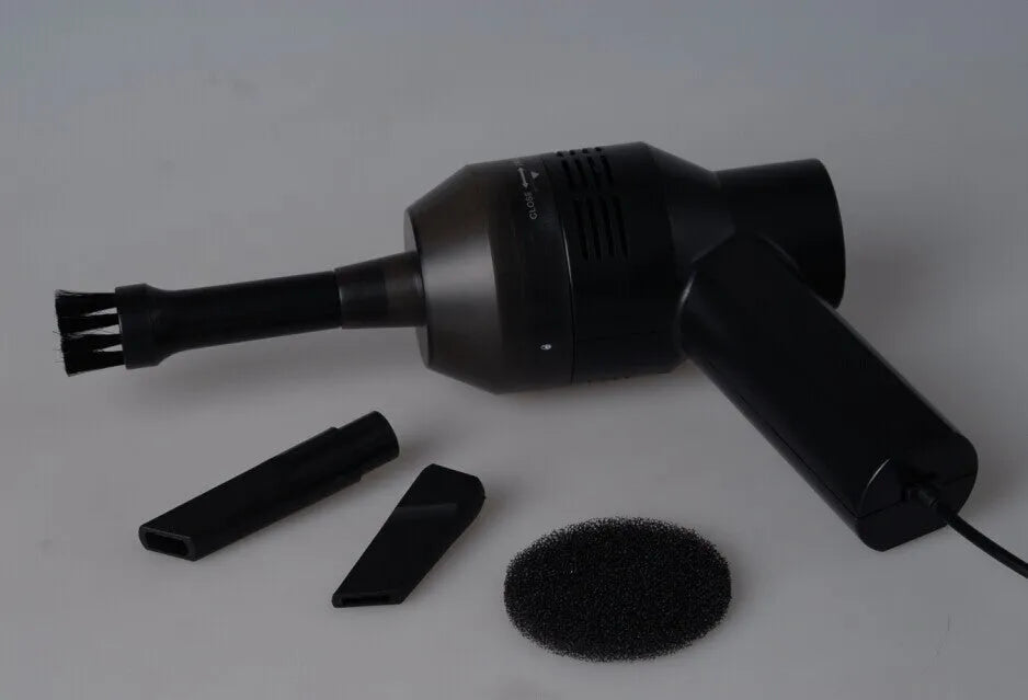 Black desktop mini vacuum cleaner with 4W power rating on a desk surface