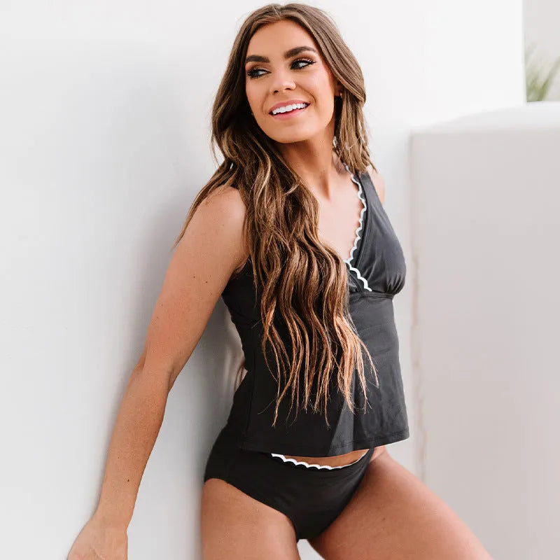 Black women's one-piece swimsuit with split leg design and sleeveless cut