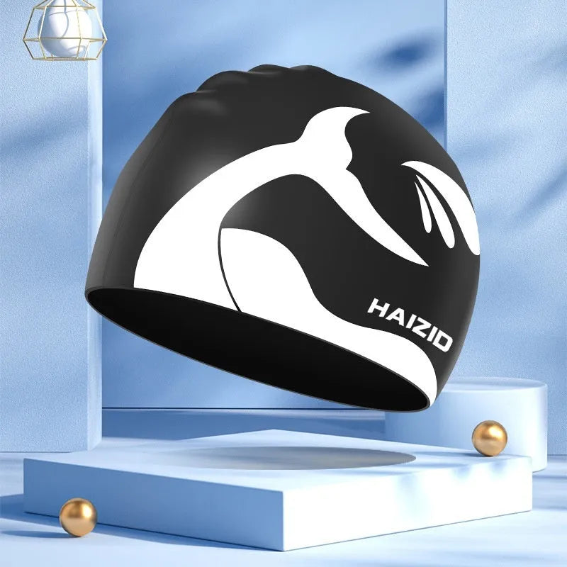Silicone swimming cap with raised whale tail pattern and integrated ear protectors in multiple colour options